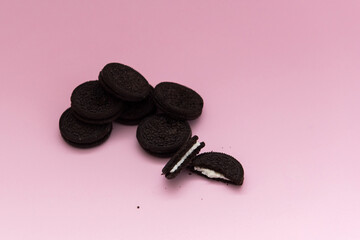 Chocolate cookie on pink background