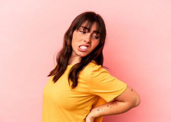 Obraz premium Young Argentinian woman isolated on pink background suffering a back pain.