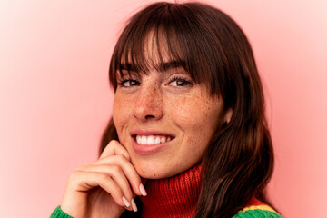 Young Argentinian woman isolated on pink background