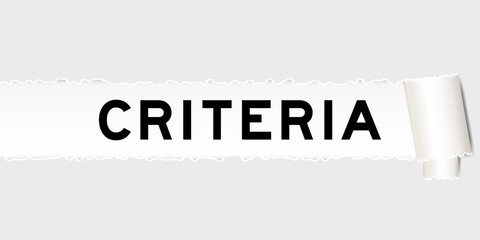 Ripped gray paper background that have word criteria under torn part