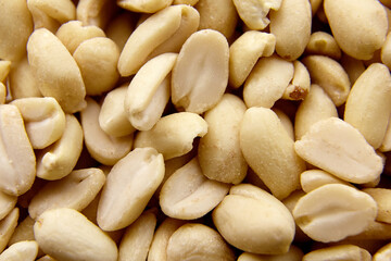 Raw blanched peanuts as food background