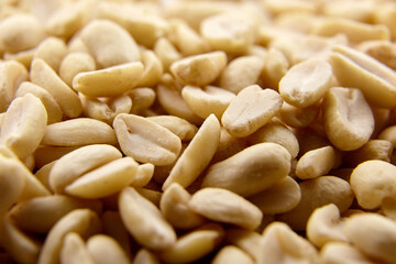 Raw blanched peanuts as food background