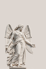 Fototapeta na wymiar Cover page with a beautiful angel as a bas relief wall sculpture, details, closeup, with copy space solid background. Concept of Religion and Religious Architecture.
