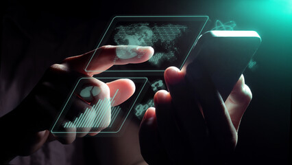Glowing business graphics charts float from the mobile phone screen.