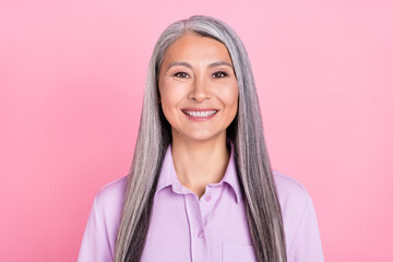 Portrait of attractive cheerful glad gray-haired woman wearing formal office shirt isolated over pink pastel color background - obrazy, fototapety, plakaty