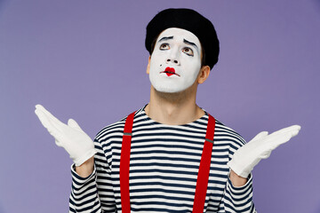 Confused preoccupied pensive perplexed young mime man with white face mask wears striped shirt...