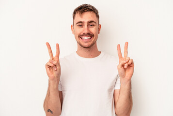 Naklejka premium Young caucasian man isolated on white background touches tummy, smiles gently, eating and satisfaction concept.