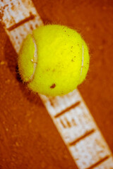 Tennis ball on the tennis court. Gravel. Tennis game. Sport, recreation concept