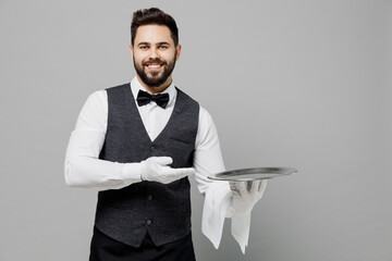Young fun barista male waiter butler man wear white shirt vest elegant uniform work at cafe show...