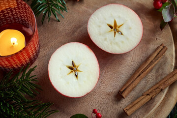 Fototapeta na wymiar Christmas decoration with an apple cut in two halves with a star