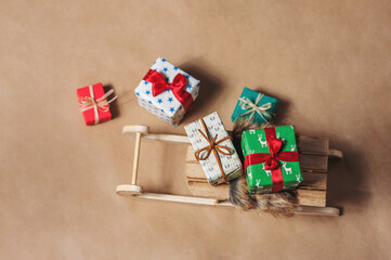 Sled with gifts on craft paper background