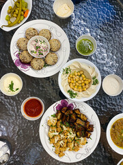 Falafel Mahshi (stuffed falafel), available in Dubai. Served with hummus, chickpeas, shatta and toum