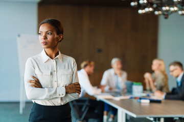 Black woman posing and looking aside in office