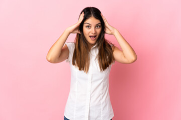 Fototapeta na wymiar Young caucasian woman isolated on pink background with surprise expression