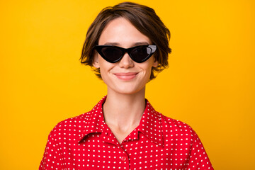 Photo of young attractive beautiful lovely smiling positive good mood girl in sunglasses isolated on yellow color background