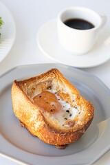 egg on bread for breakfast on plate and white table.