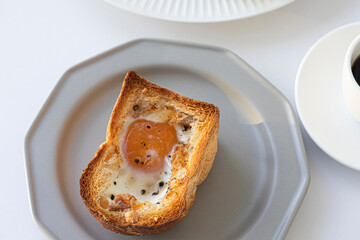 egg on bread for breakfast on plate and white table.