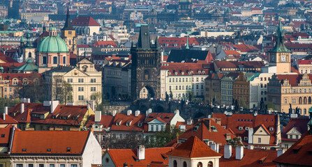 Obraz premium Scenic view of the old district of the Czech capital Prague with many red roofs, churches and towers