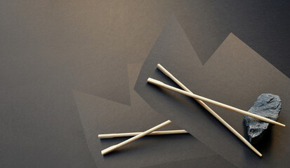 Dark background. Chinese food sticks. East Asian vibes. Minimalism