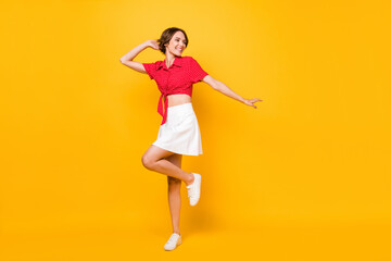 Fototapeta na wymiar Full size photo of optimistic nice brunette lady look empty space wear shirt skirt isolated on yellow color background