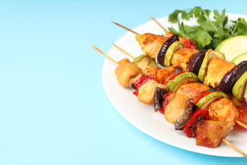 Concept of tasty food with chicken shashlik on blue background