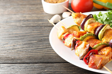 Concept of tasty food with chicken shashlik on dark wooden background