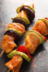 Tasty chicken shashlik on dark textured background