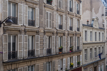 Fototapeta na wymiar Side of vintage Paris apartment buildings on sunny day