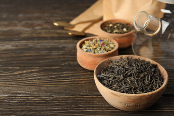 Concept of cooking tea with different types of tea on wooden background