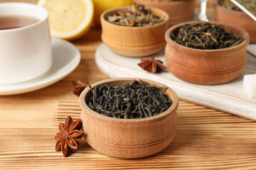 Concept of cooking tea with different types of tea on wooden background