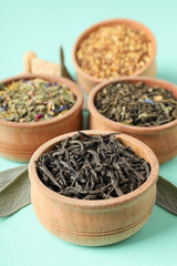 Concept of cooking tea with different types of tea on mint background