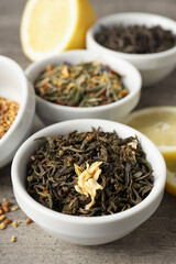 Concept of cooking tea with different types of tea on gray wooden background