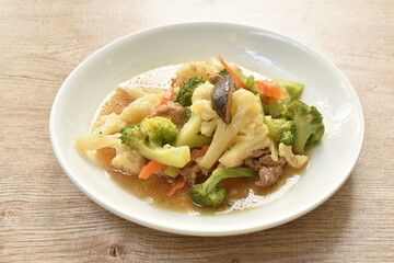 stir fried Cauliflower and broccoli with mushroom in oyster sauce on plate