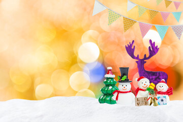 Christmas background, Snowman friends and purple reindeer with gift box and party flag over blurred bokeh background