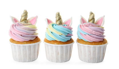 Three cute sweet unicorn cupcakes on white background