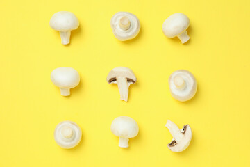Flat lay composition with champignons on yellow background