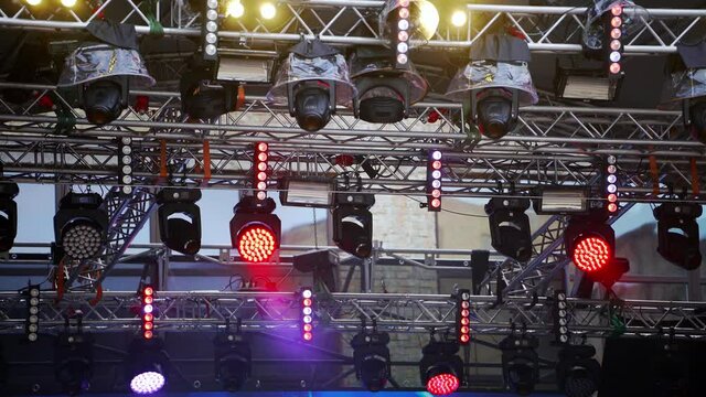 Concert stage lighting. Multicolored light at a music festival. Floodlight lights flashing. Flashlights disco lights