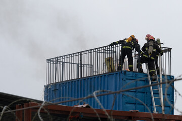 firefighters extinguish a fire in a warehouse