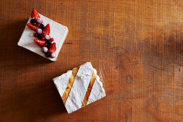 Assorted cakes on wooden table background