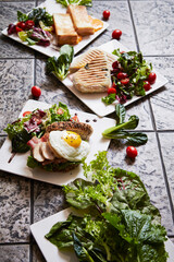 Sandwich and fried egg, fresh vegetables, variety of brunch