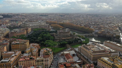 Aerial drone view of iconic Castel Sant'Angelo (castle of Holy Angel) and Ponte or bridge Sant'Angelo with statues in river of Tiber next to famous Vatican, Rome, Italy