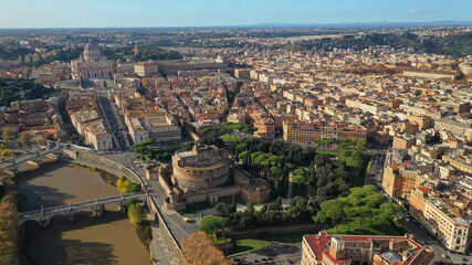 Aerial drone view of iconic Castel Sant'Angelo (castle of Holy Angel) and Ponte or bridge Sant'Angelo with statues in river of Tiber next to famous Vatican, Rome, Italy - obrazy, fototapety, plakaty