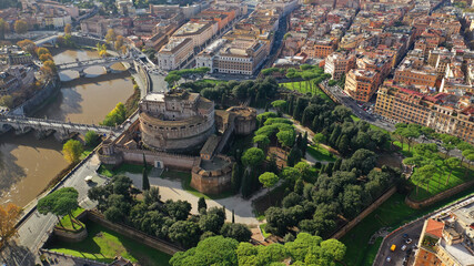 Aerial drone view of iconic Castel Sant'Angelo (castle of Holy Angel) and Ponte or bridge Sant'Angelo with statues in river of Tiber next to famous Vatican, Rome, Italy - obrazy, fototapety, plakaty