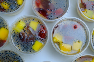 Colorful of several cups of fruit pudding on the table