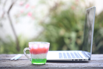 Glass of mixed juice and laptop