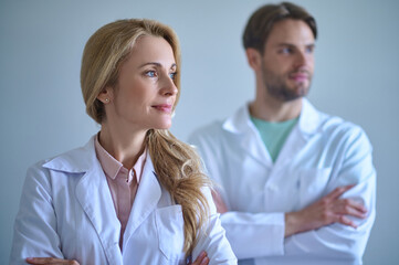 Woman looking to side and man behind