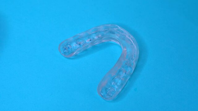 Doctor grabbing a dental retainer or dental splint