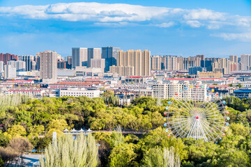 Ferris wheel and city skyline scenery in Qingcheng Park, Hohhot, Inner Mongolia, China © Govan