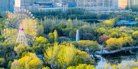 Ferris wheel and city skyline scenery in Qingcheng Park, Hohhot, Inner Mongolia, China
