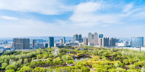 Ferris wheel and city skyline scenery in Qingcheng Park, Hohhot, Inner Mongolia, China